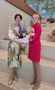 NBCC CEO Lyne Biewinga handing flowers to Janet Poot
