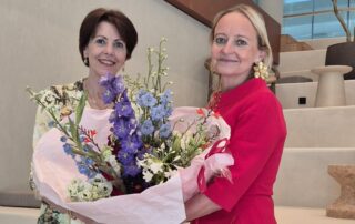 NBCC CEO Lyne Biewinga handing flowers to Janet Poot